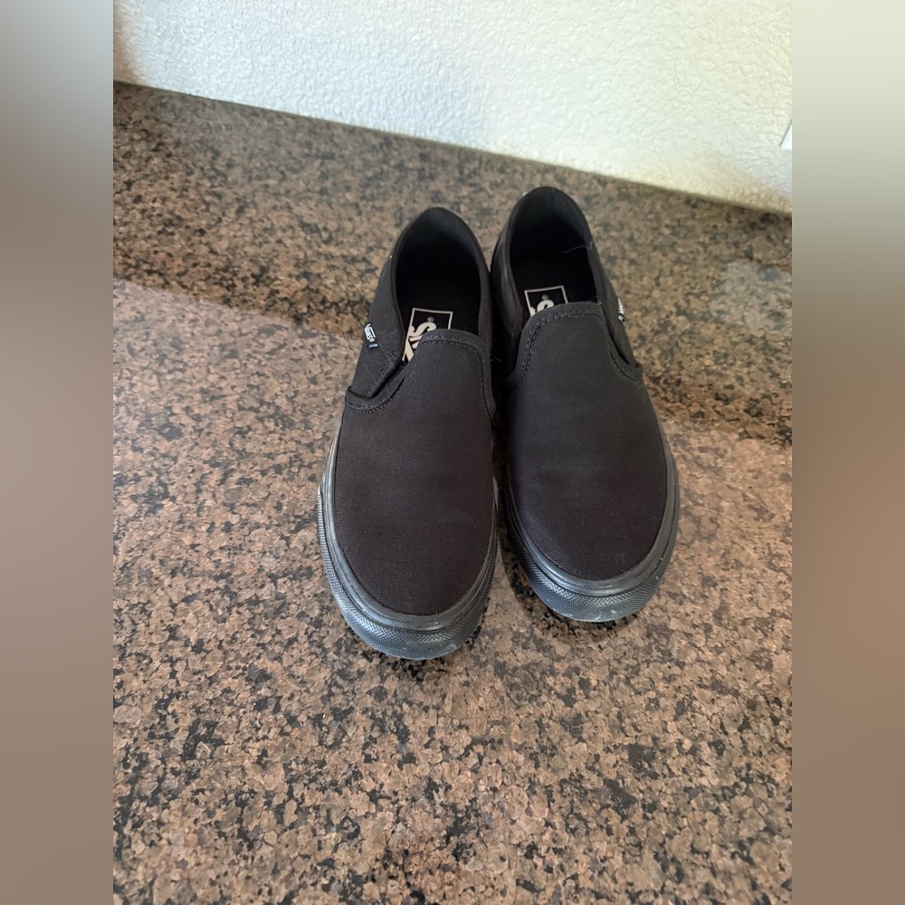 Vans women’s Classic Black Slip-On Sneakers